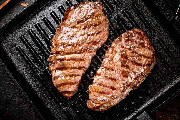 istock Aromatic grilled steak in a frying pan. 1375586077