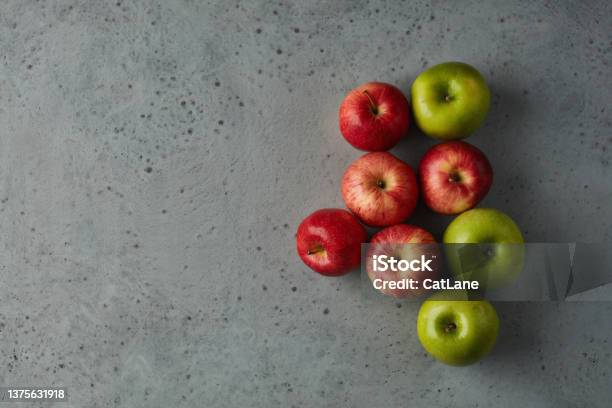 Still Life With Red And Green Apples Arranged On A Gray Surface Stock Photo - Download Image Now