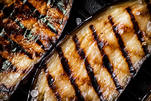 Delicious slices of grilled eggplant. Macro background. High quality photo