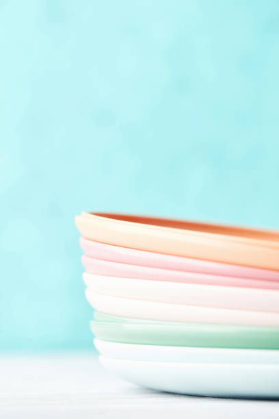 istock Collection of pastel colored plastic reusable plates in a bright setting 1375644511