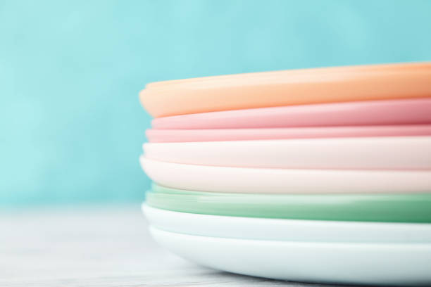 istock Collection of pastel colored plastic reusable plates in a bright setting 1375645013