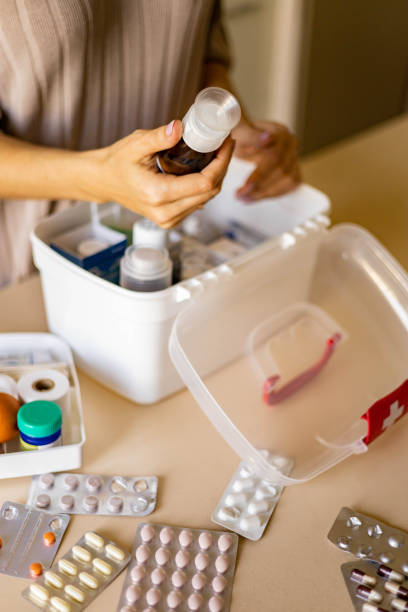istock Closeup female hand placing medicament domestic first aid kit. Storage organization emergency supply 1375647151