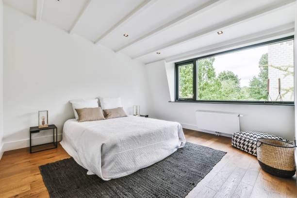 istock Stylish bedroom with a large window 1375649703