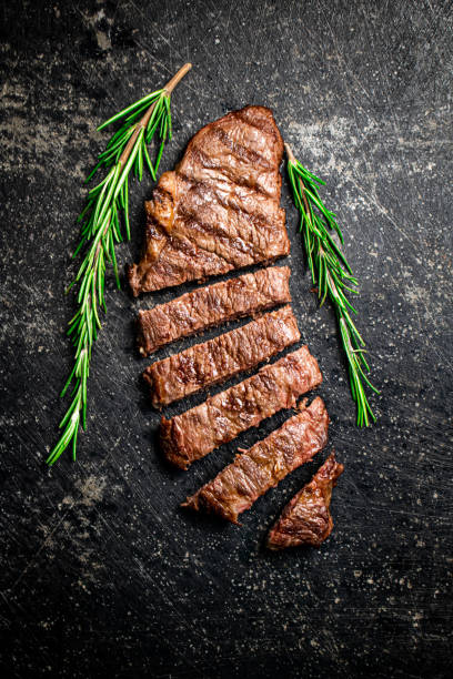 grilled steak with a sprig of rosemary. - top sirloin imagens e fotografias de stock