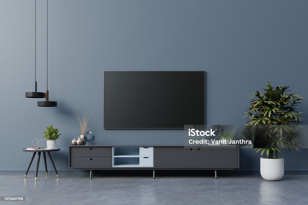 LED TV on the dark blue wall in living room,minimal design. LED TV on the dark blue wall in living room,minimal design.3d rendering Television Set Stock Photo