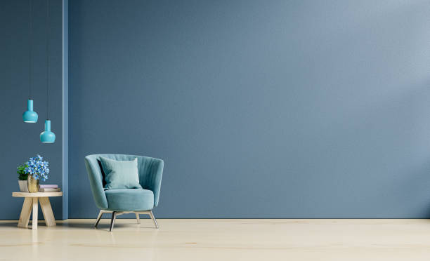 living room interior mockup in warm tones with armchair on empty dark blue wall background. - office indoors contemporary inside of imagens e fotografias de stock