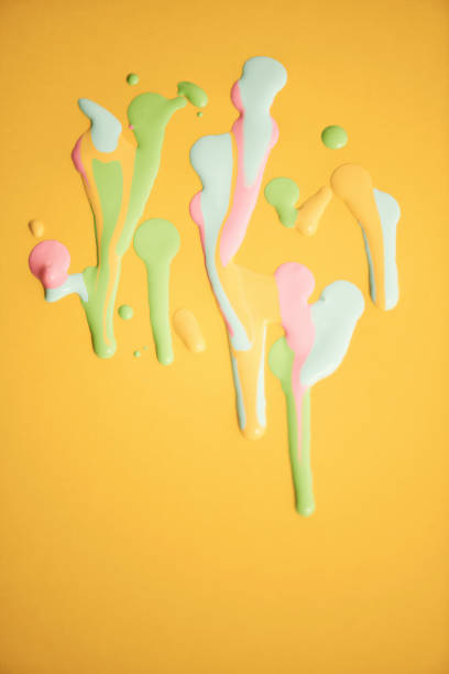 Yellow abstract background with splats of pastel colored paint