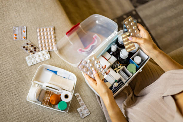 istock Closeup female hand placing medicament domestic first aid kit. Storage organization emergency supply 1375655908