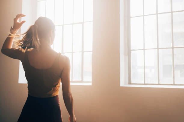 istock Anonymous Sportswoman Facing the Window in the Gym (Haze Effect) 1375659753