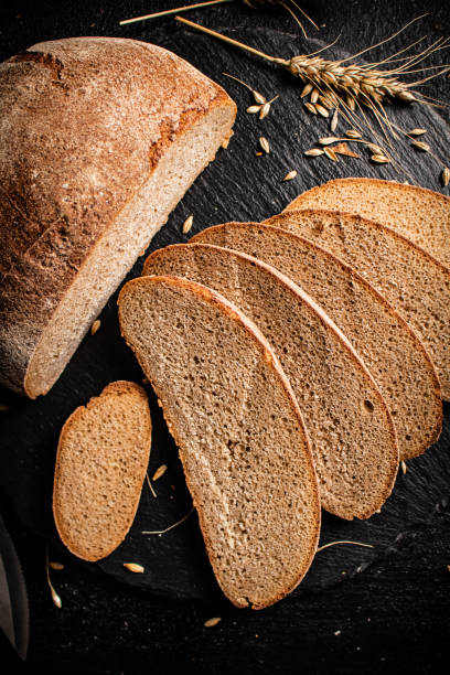 istock Slices of fresh bread on a stone board. 1375662057