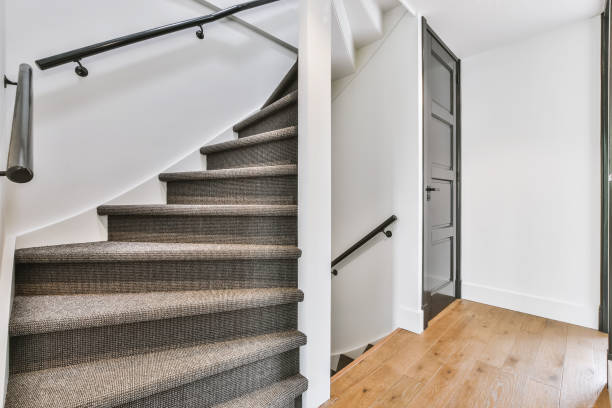 istock Stylish grey staircase with white walls 1375673161
