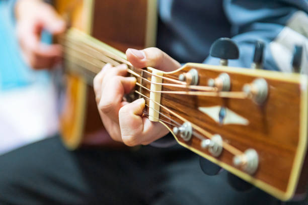 istock Man's hand playing acoustic guitar 1375716365