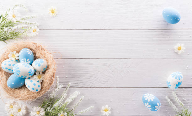istock Happy easter! colourful Easter eggs and flower on white wooden background. 1375750305