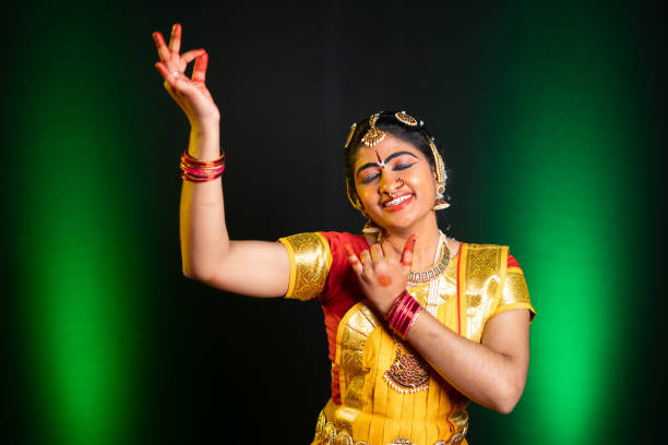 istock Indian bharathanatyam dancer in krishna pose or gesture with eye closed at stage during performance - concept of Indian culture, traditional dress and classic dancers 1375757051