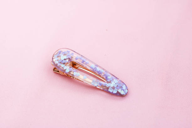 istock Purple hair clip on pink background. 1375796178