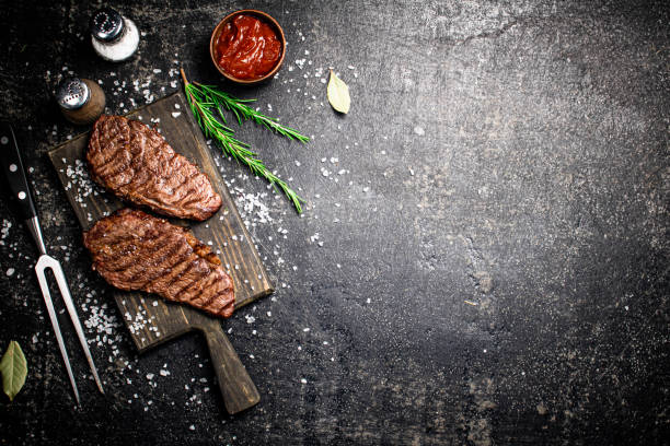 istock Grill steak on a wooden cutting board. 1375804219