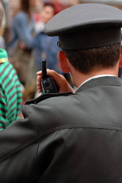 policeman with radio in the crowd