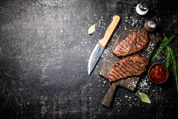 istock Grill steak on a wooden cutting board. 1375837313