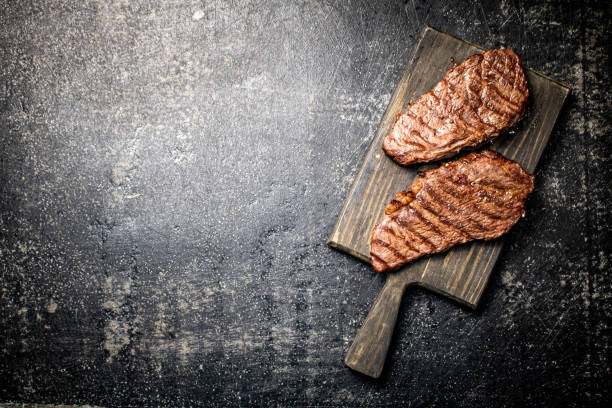 grill steak on a wooden cutting board. - top sirloin imagens e fotografias de stock