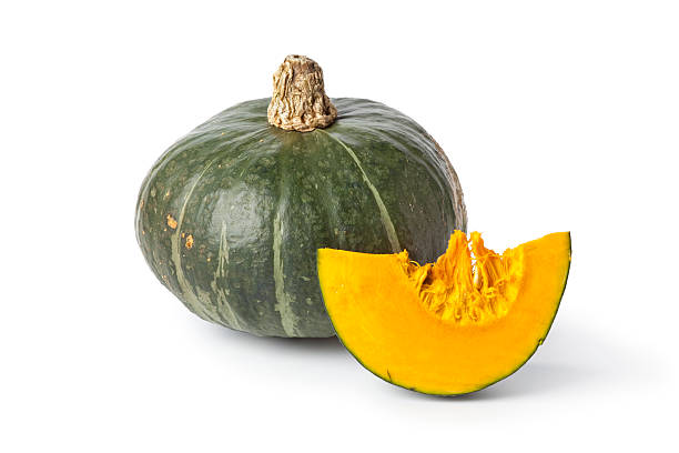 istock Green pumpkin with a slice on white background 137584806