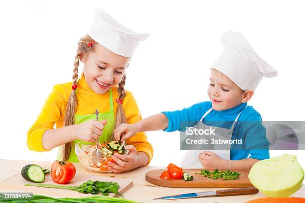Young Girl And Boy Happily Making A Salad Together Stock Photo - Download Image Now - Apron, Boys, Cabbage