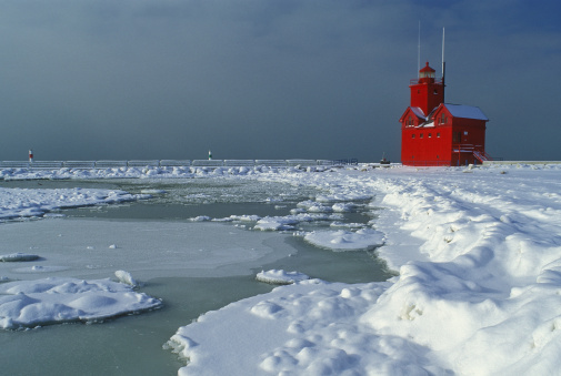 Winter shoreline of Lake Michigan and Holland Lighthouse, Michigan, USA