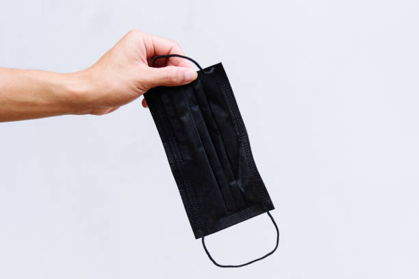 istock hold the black hygienic mask 1375869900