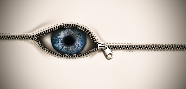 Unusual frightening background with an eye peeping out of an opening zipper