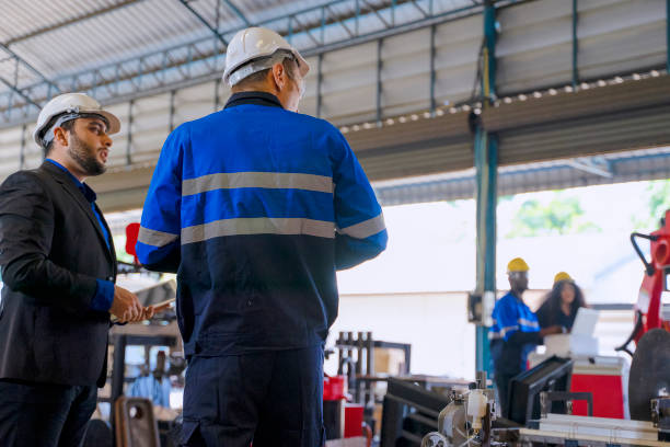 istock Employees are working at factory with robotic arms. 1375878275