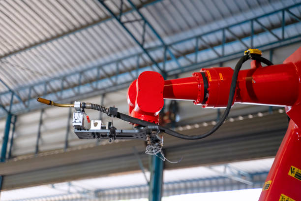 istock Employees are working at factory with robotic arms. 1375878352