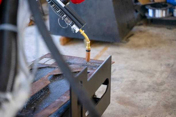 istock Employees are working at factory with robotic arms. 1375878353