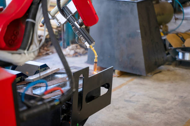 istock Employees are working at factory with robotic arms. 1375878365