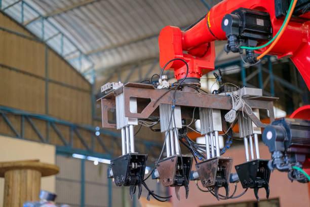 istock Employees are working at factory with robotic arms. 1375879421