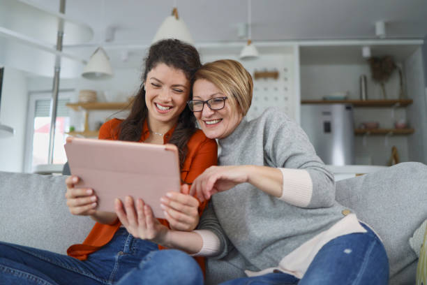 istock Mother and daughter using tablet at home 1375892604