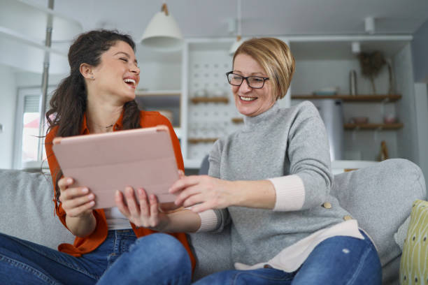 istock Mother and daughter using tablet at home 1375892605