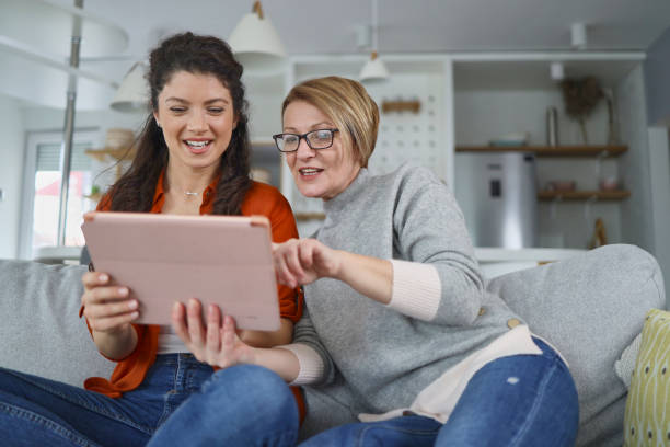 istock Mother and daughter using tablet at home 1375892609