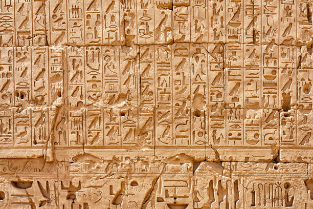 Egyptian hieroglyphs on the wall Egyptian hieroglyphs in Karnak Temple, Luxor, Egypt hieroglyphics stock pictures, royalty-free photos & images