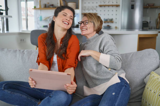 istock Mother and daughter using tablet at home 1375896387