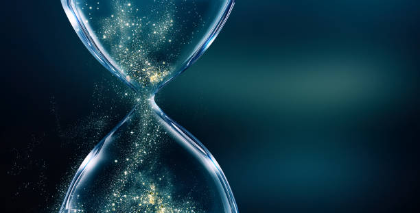 Glass hourglass with glowing sand Glass hourglass on dark background with glowing sand hourglass stock pictures, royalty-free photos & images