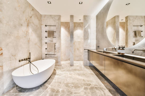 Attractive bathroom with oval bathtub and marble floor and walls