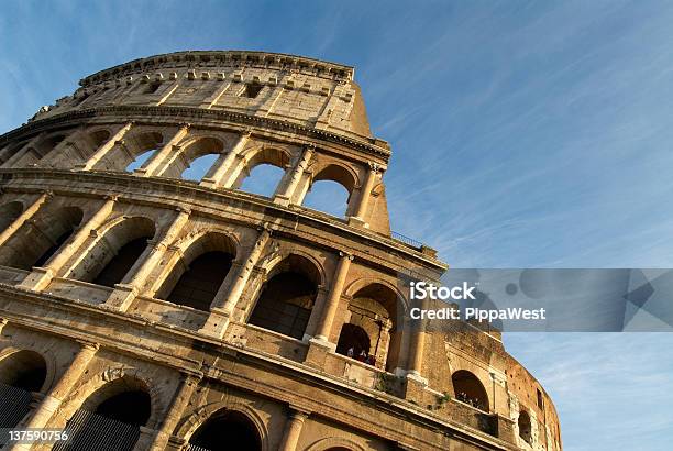 A Large Section Of The Colosseum Among Blue Sky Stock Photo - Download Image Now - Amphitheater, Ancient, Architecture