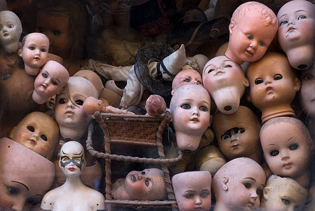 Collection of doll heads in a room stock photo