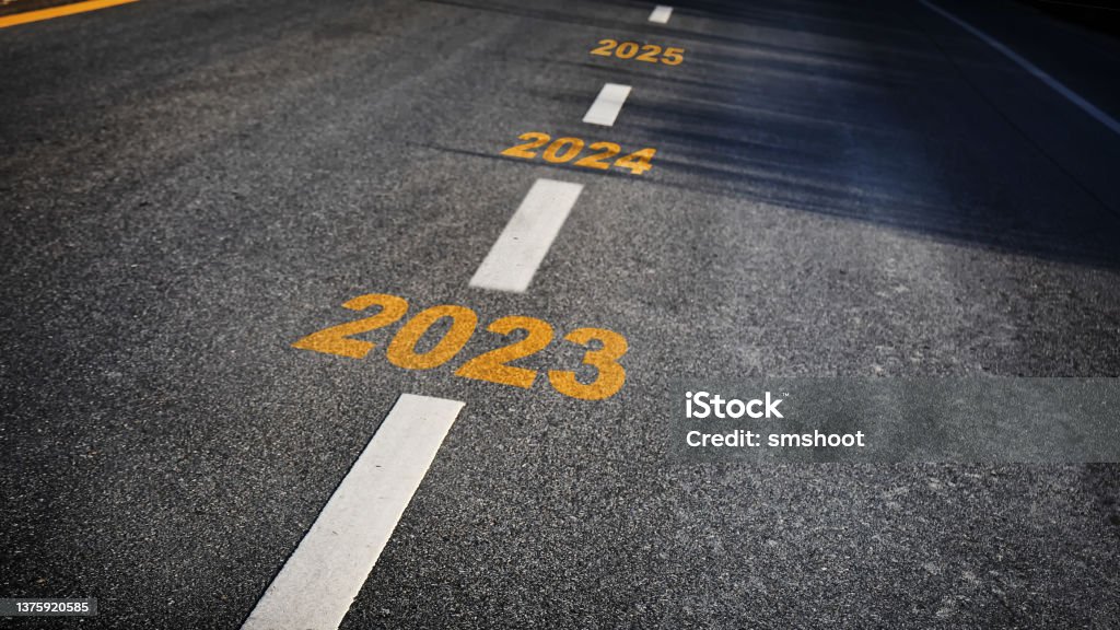 Happy new year concept and business challenge idea Number of 2023 to 2025 on asphalt road surface with marking lines 2023 Stock Photo