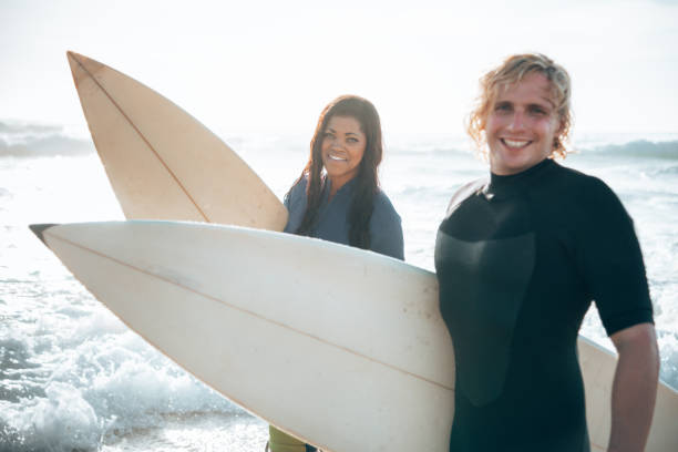 istock surfer friends resting on the beach 1375925065