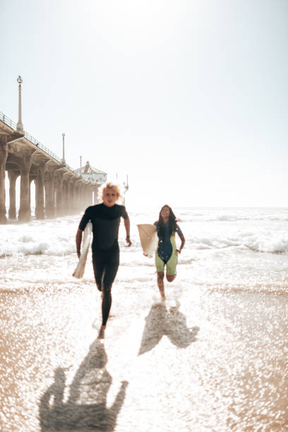 istock surfer friends resting on the beach 1375925592