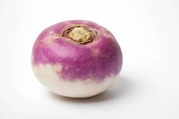 One whole purple headed turnip on white background