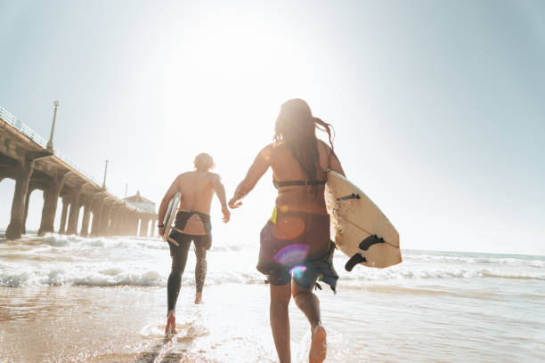 istock surfer friends resting on the beach 1375926115