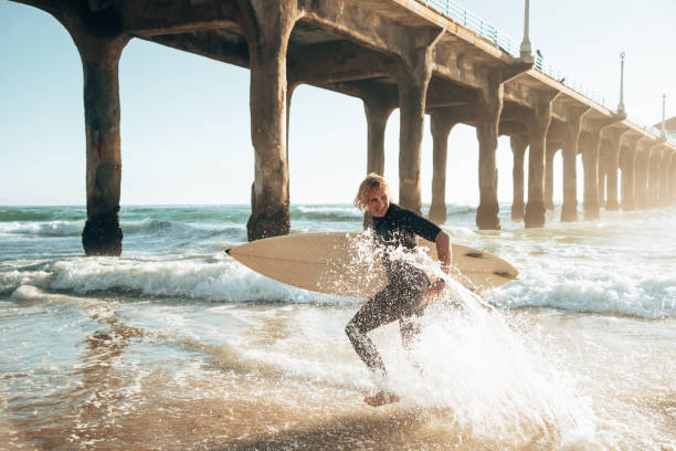istock surfer man on manhattan beach california 1375927178
