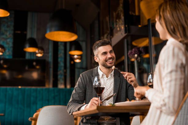 istock Happy man eating lunch with his girlfriend in a restaurant. 1375928230