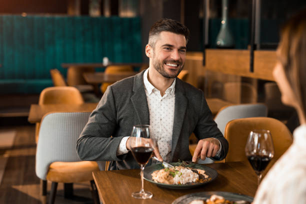 istock Happy man eating lunch with his girlfriend in a restaurant. 1375928242